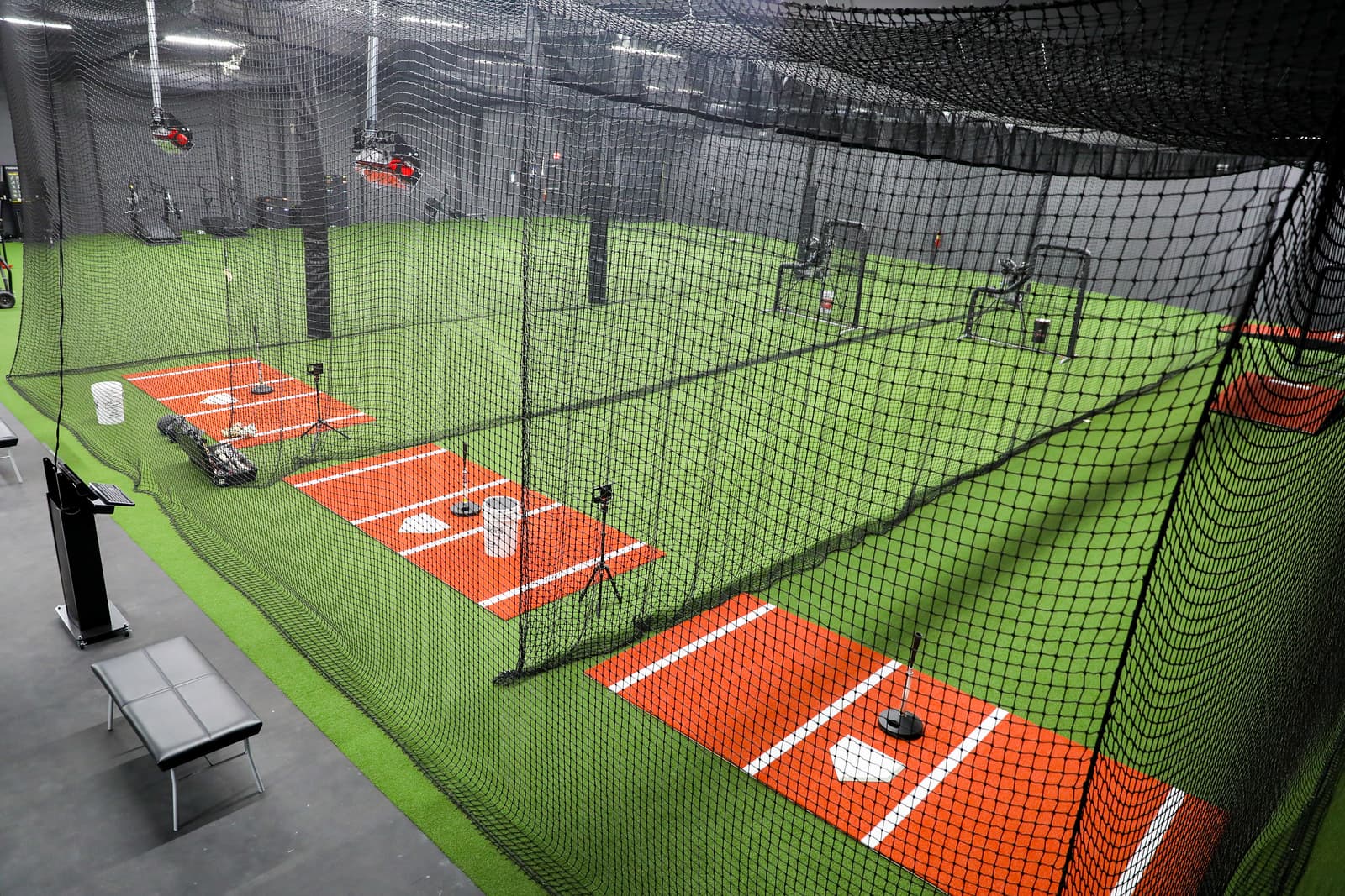 Indoor turf lanes with retractable cages